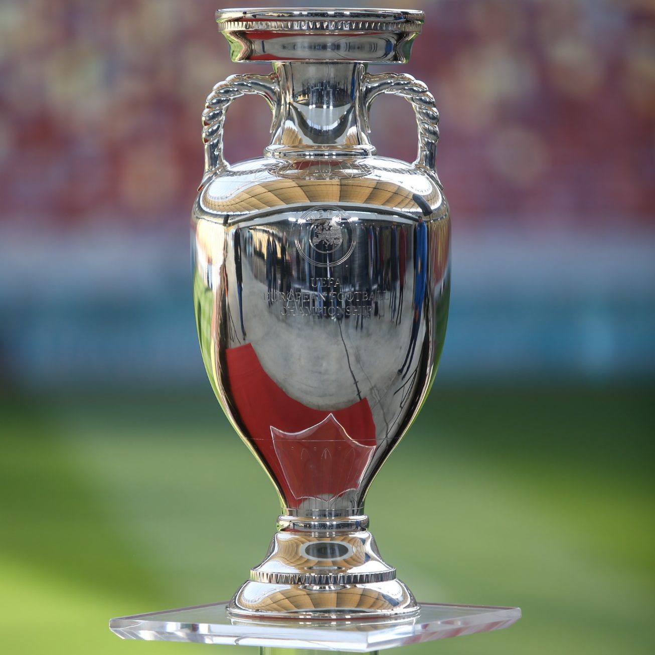 The European Championship trophy, which is silver and has two small handles, one each side of the neck of the trophy.